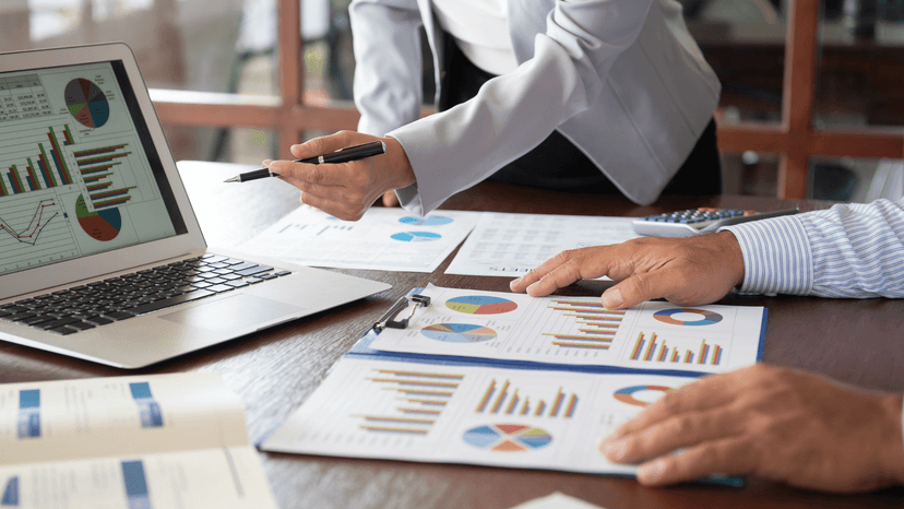 two people reviewing business reports