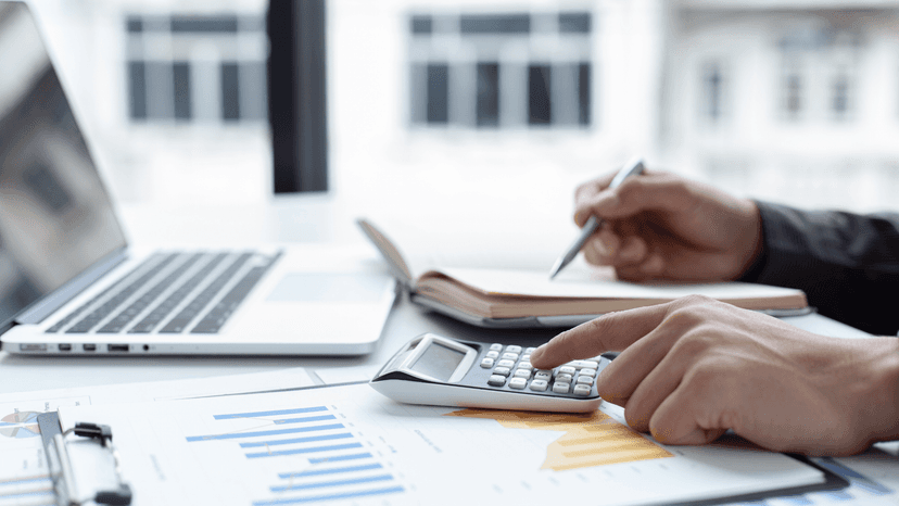 hands, laptop, calculator, paperwork