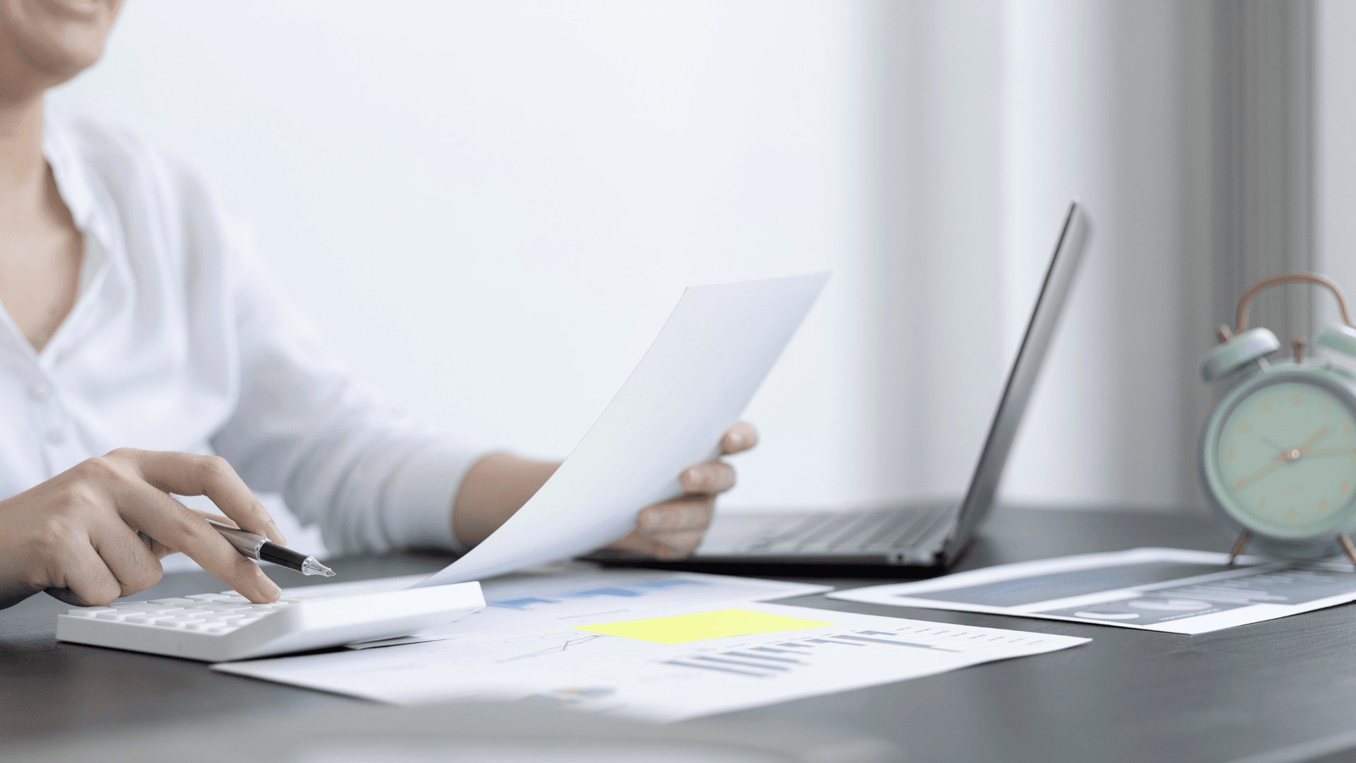 woman with paperwork and calculator