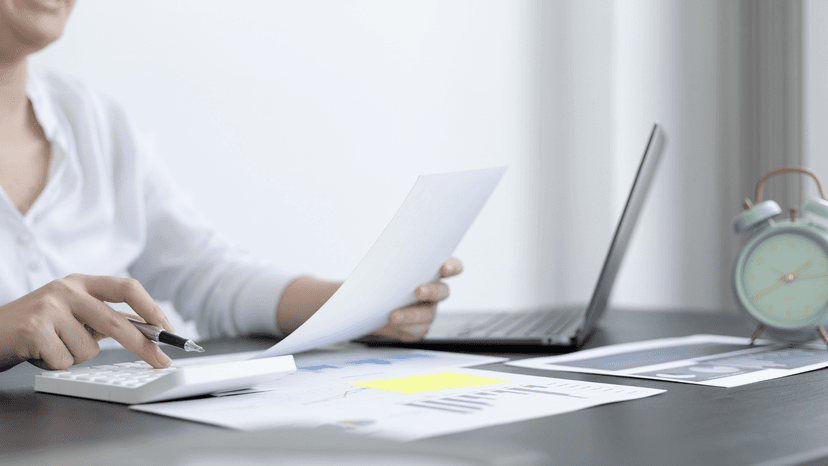 woman with paperwork and calculator