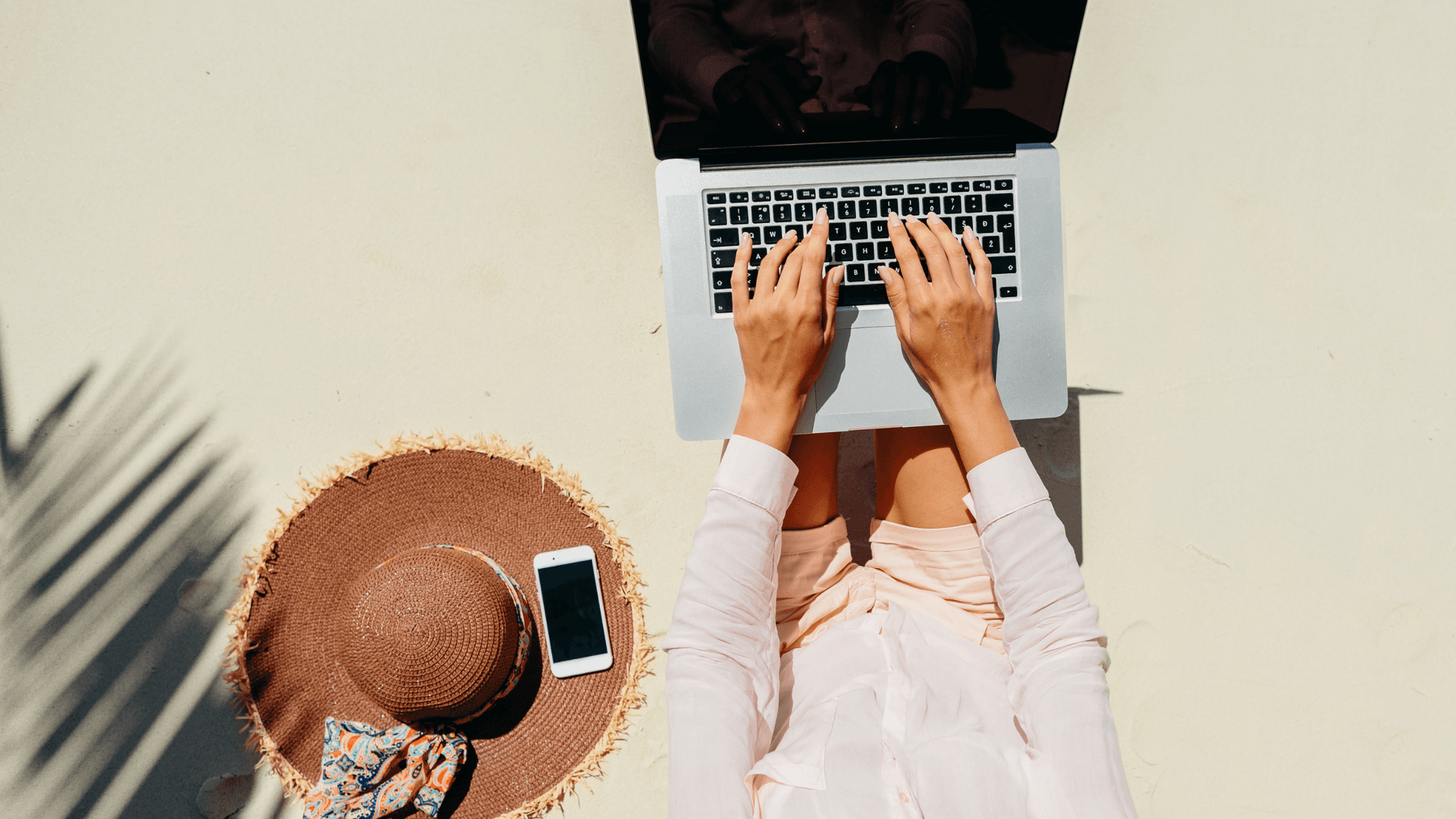 woman working on laptop at the beach