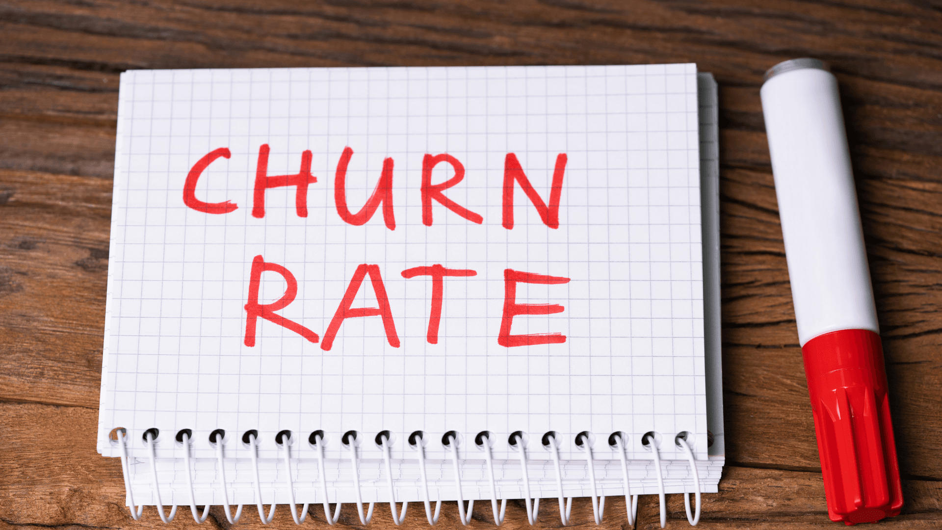 "Churn Rate" on note book and marker