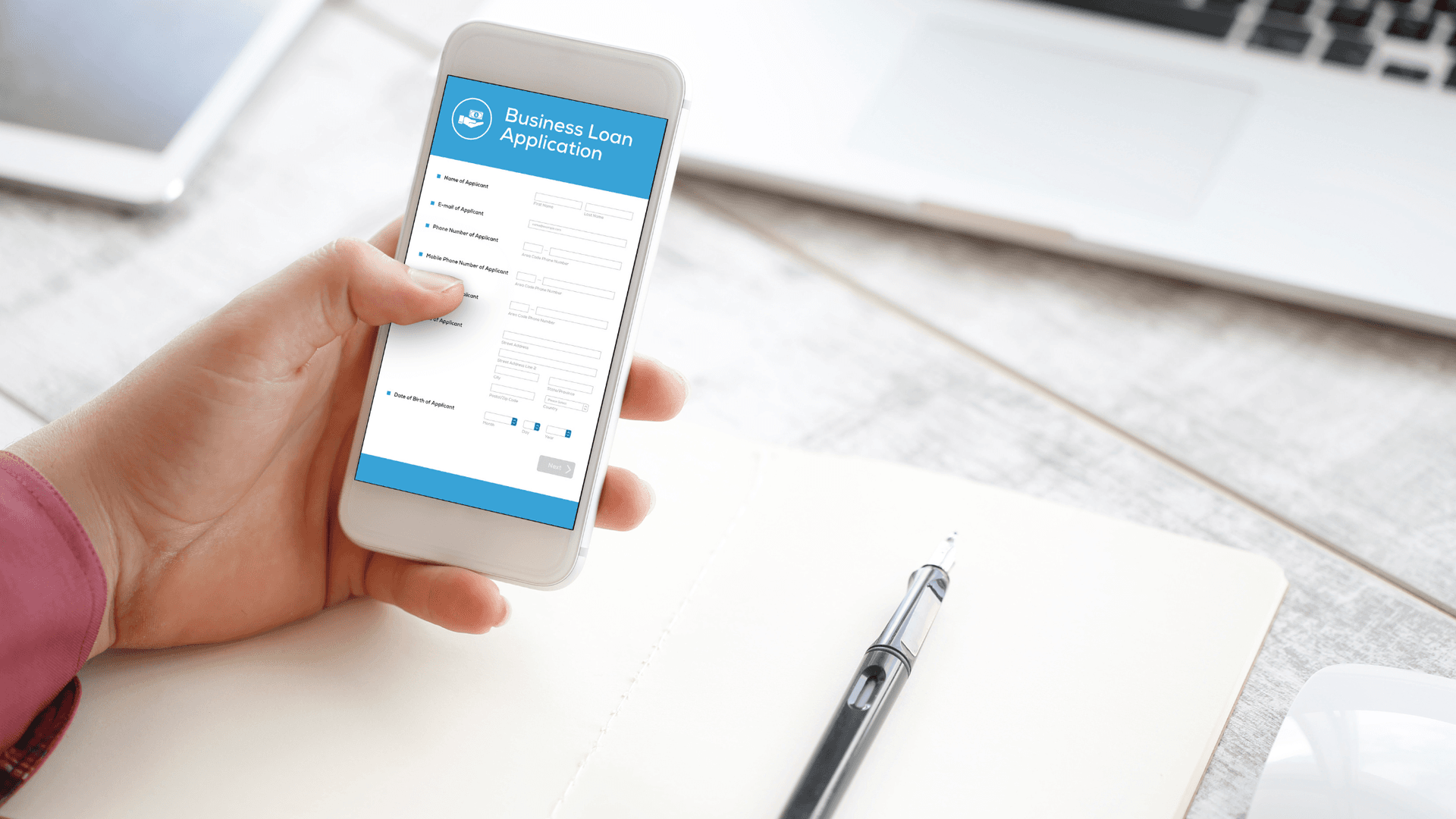 person using iphone to access business loan application