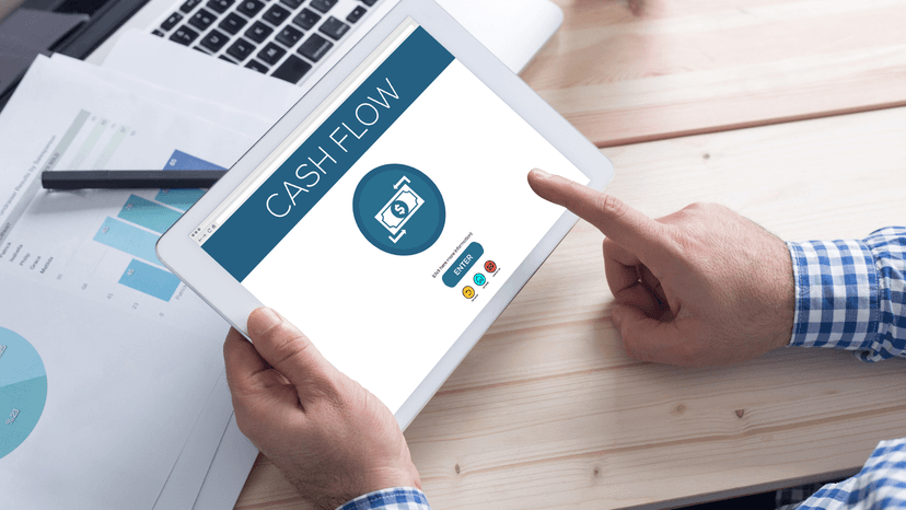 man looking at tablet reviewing cash flow