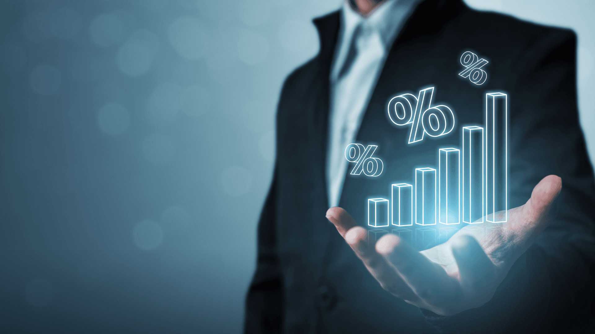 man in suit holding digital chart of increasing percentage