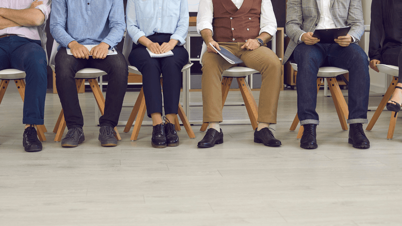 multiple men and women shown from the waist down sitting in a waiting room