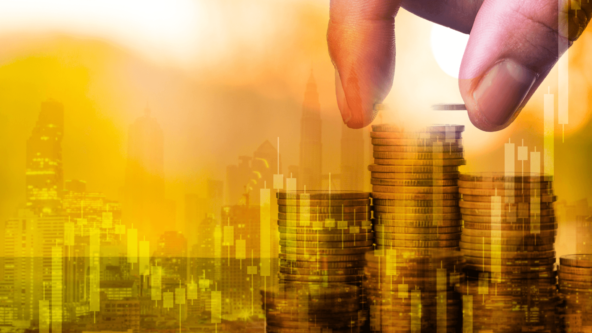 hand stacking money behind graphic of charts