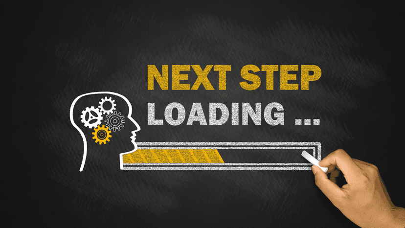 Next Step, Loading... on chalk board with loading menu bar drawn on a chalk board