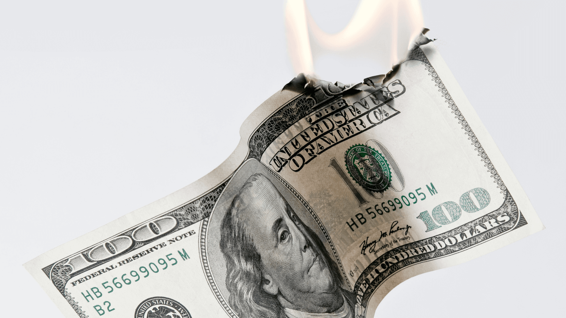 US $100 bill on fire