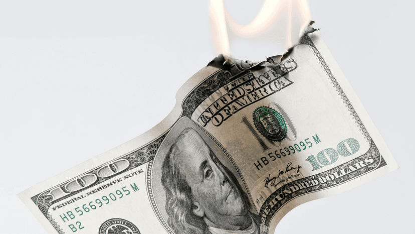 US $100 bill on fire