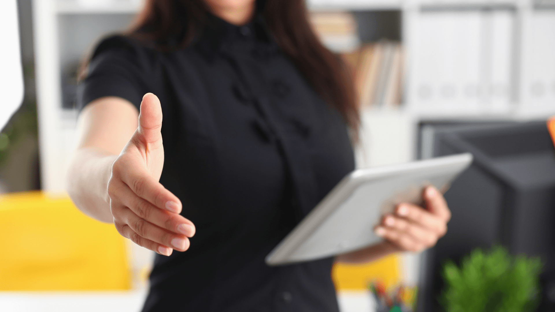 woman holding iPad with outstretched hand for shaking