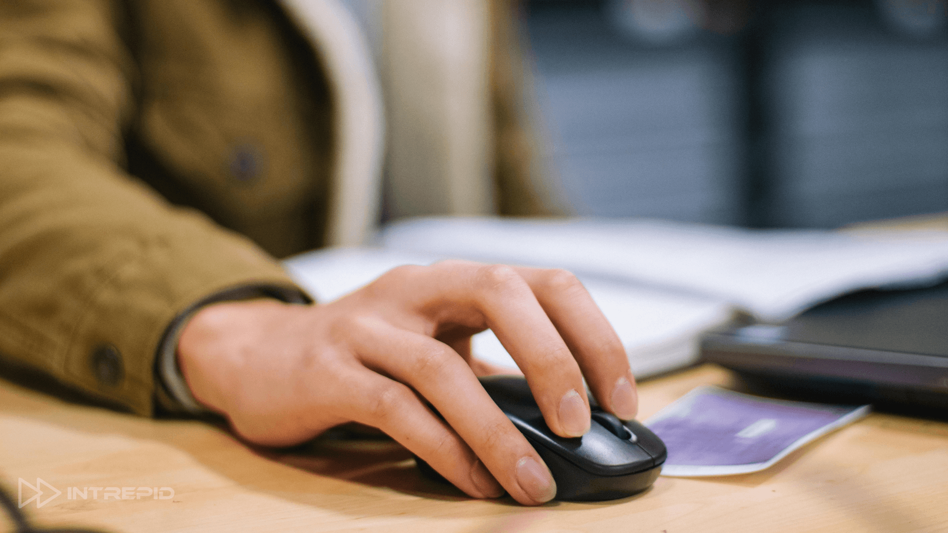 persons hand on a computer mouse ready to click