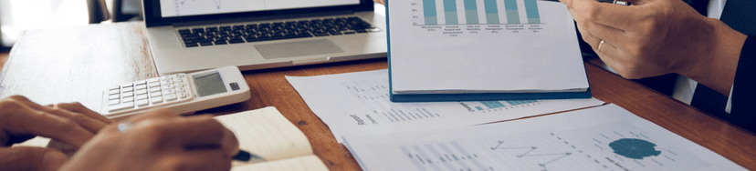 image of two people in a meeting looking at charts
