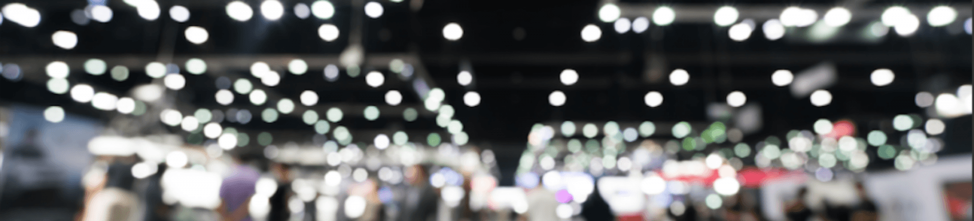 background image of a blurry trade show event