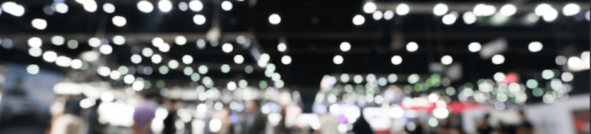 background image of a blurry trade show event