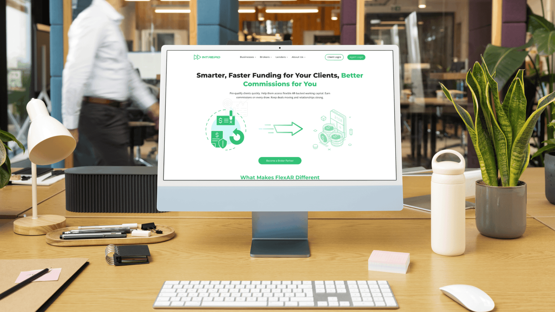 Modern office workspace with a desktop computer displaying the Intrepid Finance FlexAR webpage, highlighting smart, fast funding and broker commissions.