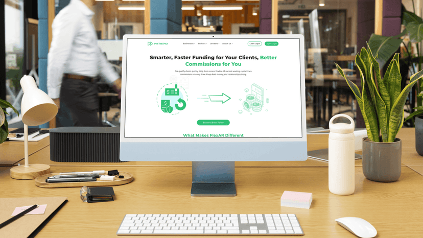 Modern office workspace with a desktop computer displaying the Intrepid Finance FlexAR webpage, highlighting smart, fast funding and broker commissions.